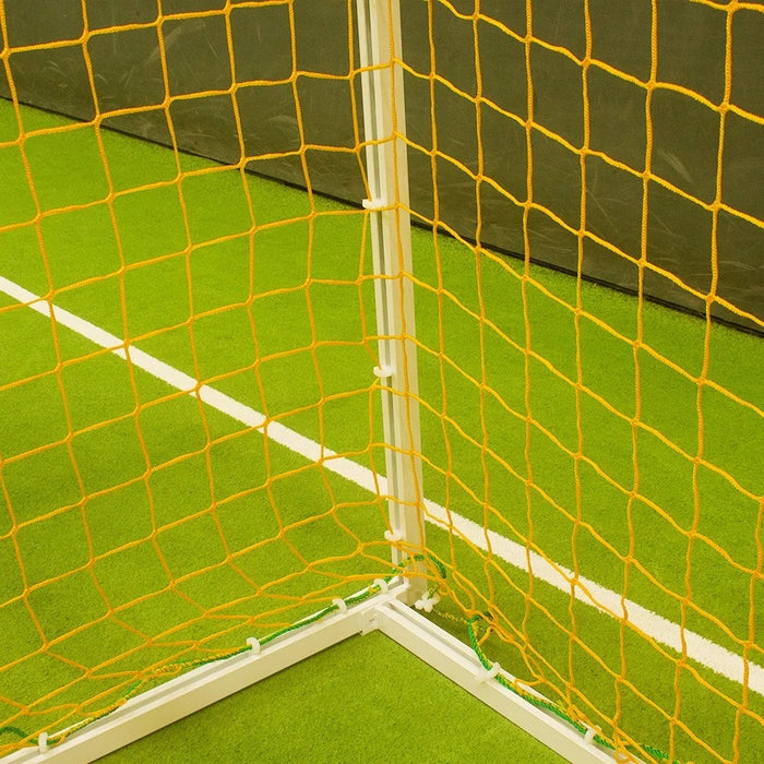 Yellow 4mm square-mesh futsal net fitted to a white 3m x 2m goal frame, corner detail